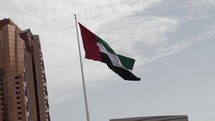 United Arab Emirates flag blows in epic, cinematic slow motion in Abu Dhabi, the capital of United Arab Emirates.