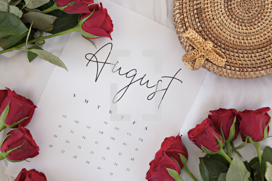 red roses on a calendar of August 