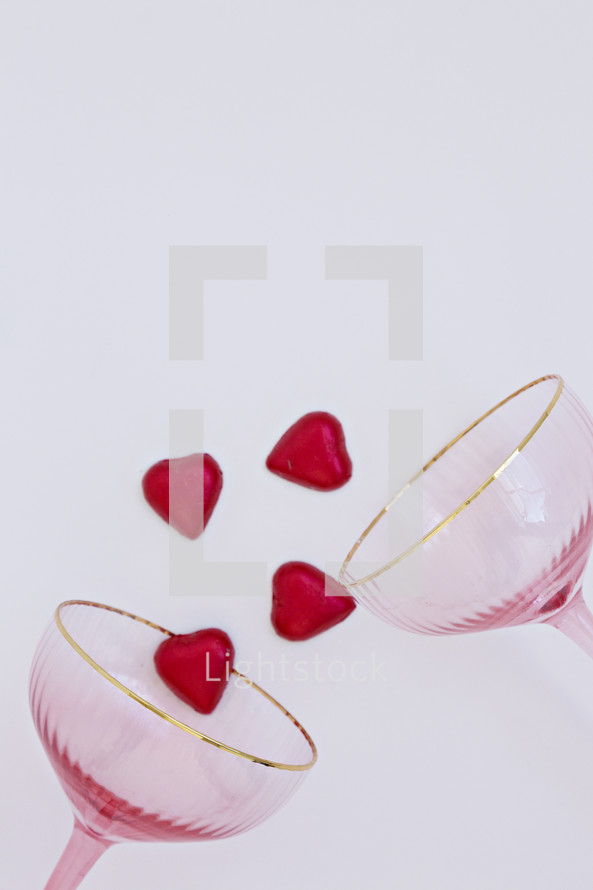 champagne glasses and red heart candies 
