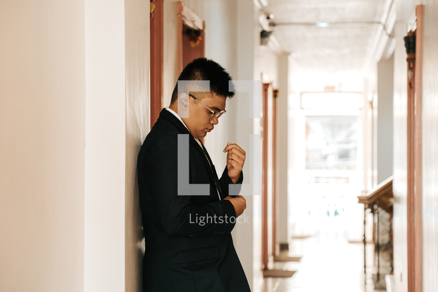 a groom standing in a hallway 