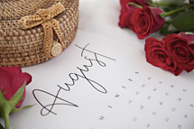 red roses and a basket on an August calendar 