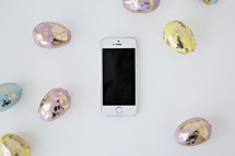 pastel gold speckled Easter eggs and cellphone 