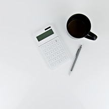 calculator, pen, and mug 