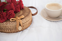 red roses on a basket and coffee cup 