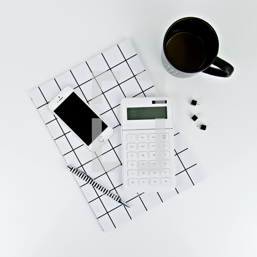 calculator, pen, black and white, journal, tacks, coffee mug, iPhone, desk 