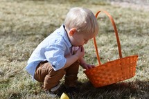 toddler with an Easter basket eating candy 