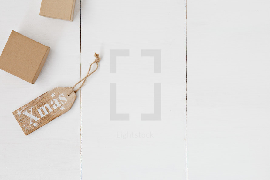 gifts wrapped in brown paper on white background 