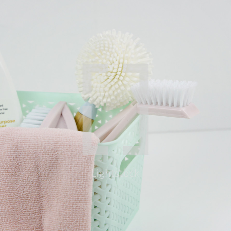 mint basket, pink towel, brushes 
