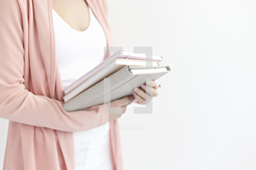 a woman holding journals 
