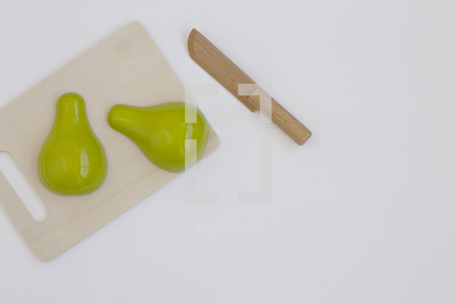 toy pear on a cutting board 