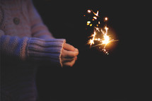 child holding a sparkler 