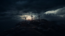 Three crosses on a hill under a dark sky.