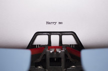 words Marry me typed on a typewriter 
