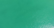 Top Down View Of Turquoise Water Of The Ocean - aerial drone shot