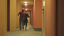 Woman being chased by a man down a hallway and taken.
