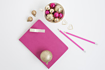 gold and fuchsia ornaments on a white background 