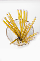 gold cocktail straws in a glass 
