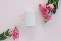 pink carnations and white coffee cup 