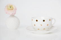 flower in a vase and polka dot tea cup 
