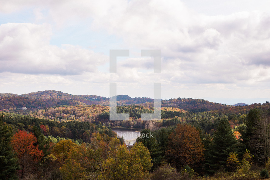 lake surrounded by trees in a forest in fall 