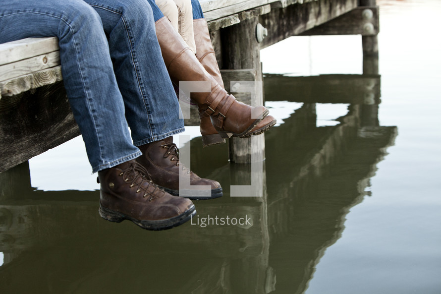 feet dangling off a dock