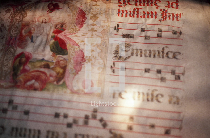Closeup of page of antique illuminated music manuscript showing the Transfiguration