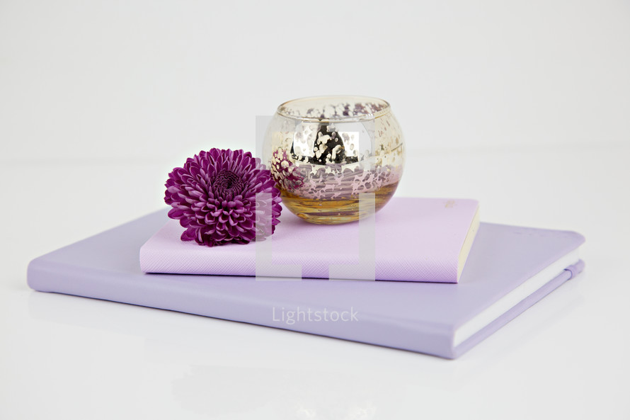 metallic bowl, purple flower, and journals 