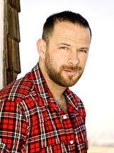 headshot of a man in a flannel shirt 