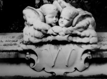Cherub angel children grave marker on a historic grave site of a child that passed away in 1895.