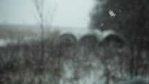 Snowflakes falling on farmland in cinematic slow motion in Christmas, winter, snow storm.
