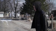 Young man, teenager with backpack and winter coat walking in cinematic slow motion. A young, teen boy walking to high school or young homeless man. 