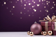 Christmas gift boxes with gold and purple colored baubles
