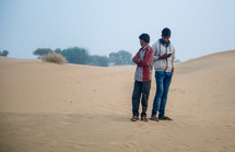 men standing in a desert in India 