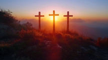 Three crosses on a hill at sunset with clouds on blue sky . Easter, resurrection, new life, redemption concept. 