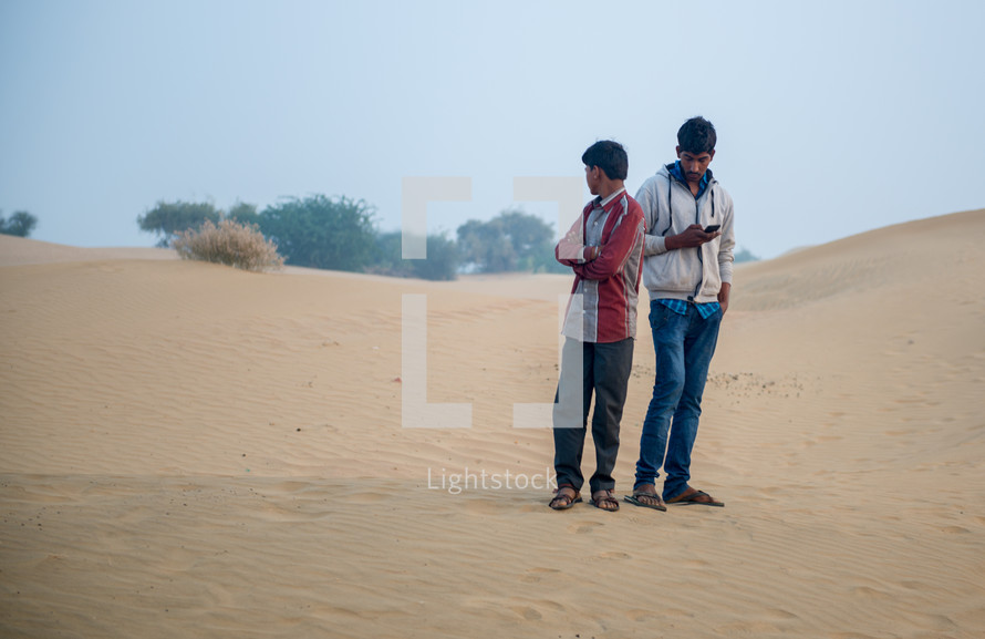 men standing in a desert in India 