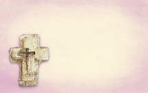 plaster cross with nails on peach pink duotone textured paint.