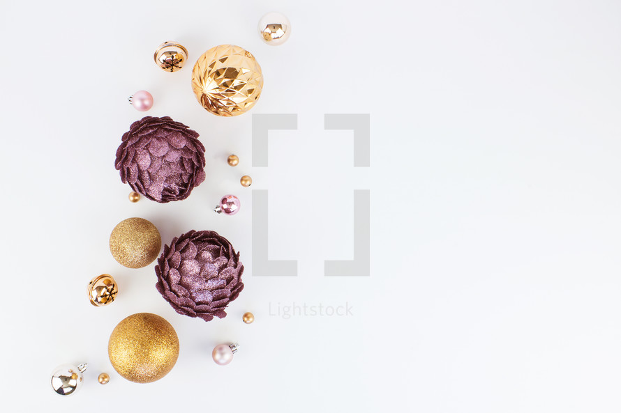 pink, purple, gold, and silver Christmas decorations on white 