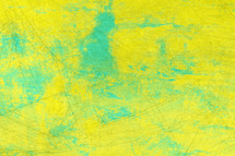 distressed background in bright colors of yellow and turquoise with painted effect and scratches