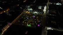 Aerial shot drone flies over main square at night in Quito