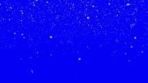 Gently falling snow on a blue screen background