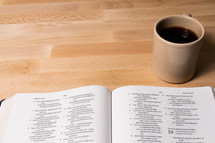 coffee mug and open Bible 