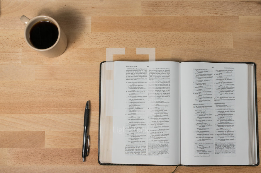 coffee mug, pen, and open Bible 