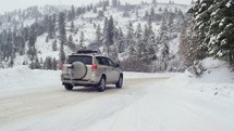 SUV driving on a snow covered road 