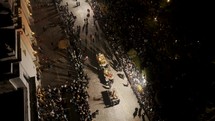 People Carrying Parade Floats In The Street During Procession Of The Holy Week In Antigua, Guatemala - aerial drone shot