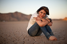 woman sitting on parched soil