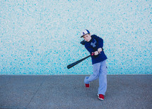 boy swinging a baseball bat 