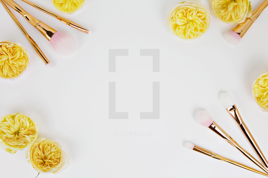 makeup brushes and gold flowers 