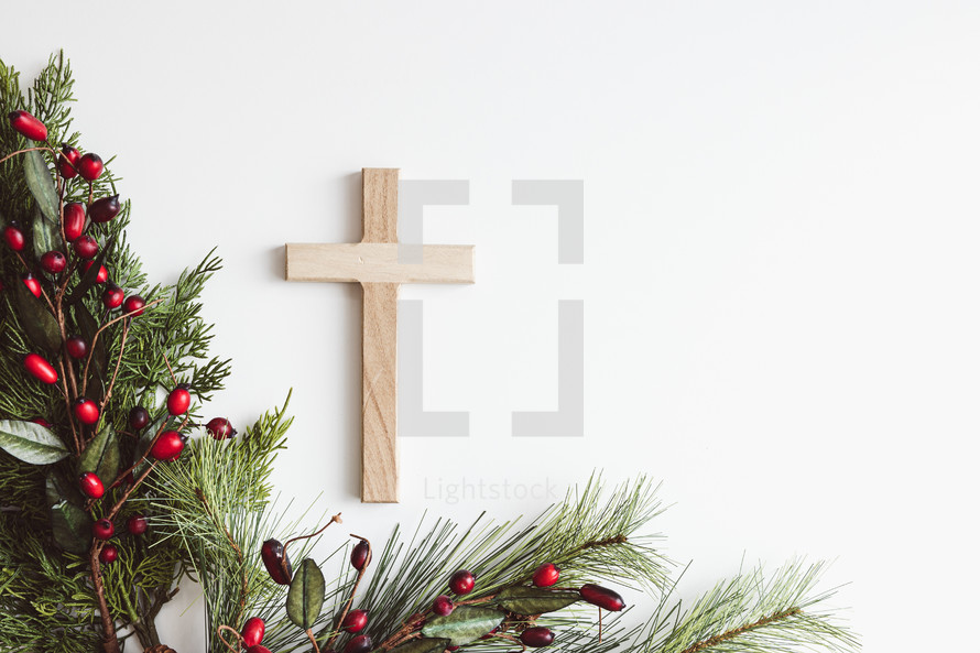 Cross and branch with red berries on a white background