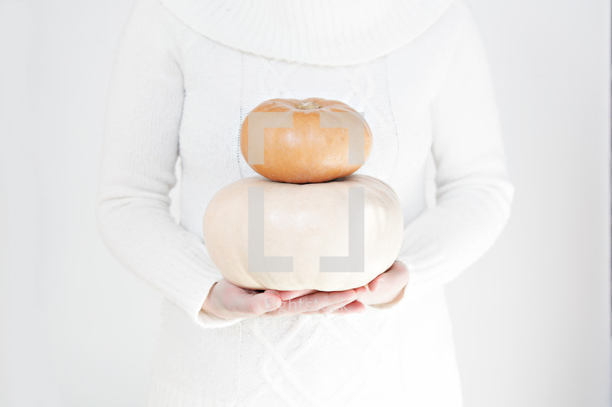 woman holding pumpkins 