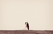 distant bride and groom kissing